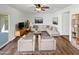 Bright living room with a neutral sectional couch, hardwood floors and ceiling fan at 12037 S Bannock St, Phoenix, AZ 85044