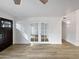 Open-concept living area with light wood floors, french doors and a dark wood front door at 12037 S Bannock St, Phoenix, AZ 85044