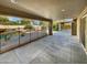 Large covered patio overlooking a sparkling pool and a lush green yard, perfect for outdoor entertaining at 12037 S Bannock St, Phoenix, AZ 85044