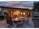 A backyard with a fire pit, an outdoor kitchen, seating, and patio at 12572 W Jasmine Trl, Peoria, AZ 85383