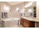 Bathroom with a soaking tub, a granite vanity, and neutral toned tile at 12572 W Jasmine Trl, Peoria, AZ 85383