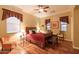 Bedroom with wood floors, ceiling fan, and plenty of natural light at 12572 W Jasmine Trl, Peoria, AZ 85383