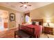 Bedroom with wood floors, ceiling fan, and comfortable furnishings at 12572 W Jasmine Trl, Peoria, AZ 85383