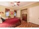 Bedroom with wood floors, ceiling fan, closet, and a chest of drawers at 12572 W Jasmine Trl, Peoria, AZ 85383