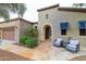 Inviting front entrance with stone walkway, sitting area, and an arched doorway at 12572 W Jasmine Trl, Peoria, AZ 85383