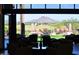 Lobby view with comfortable seating, a scenic green golf course, and mountain views at 12572 W Jasmine Trl, Peoria, AZ 85383