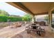 Back patio featuring an outdoor kitchen, stone fire pit, built-in barbecue, and decorative pavers at 12572 W Jasmine Trl, Peoria, AZ 85383