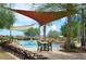 Resort-style pool with lounge chairs, umbrellas, and lush landscaping at 12572 W Jasmine Trl, Peoria, AZ 85383