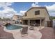 Backyard with outdoor seating, landscaping, and private pool with waterfall feature at 14406 N 129Th Ave, El Mirage, AZ 85335