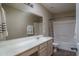 Bathroom with vanity, large mirror, and shower-tub combination at 14406 N 129Th Ave, El Mirage, AZ 85335