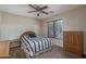 Bedroom with ceiling fan, neutral walls, carpet and window with blinds at 14406 N 129Th Ave, El Mirage, AZ 85335