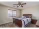 Bedroom with ceiling fan, neutral walls, carpet, and window with blinds at 14406 N 129Th Ave, El Mirage, AZ 85335