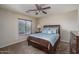 Bedroom with ceiling fan, neutral walls, carpet, and window with blinds at 14406 N 129Th Ave, El Mirage, AZ 85335