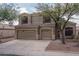 Charming two-story home featuring a three-car garage, desert landscaping, and well-maintained stucco exterior at 14406 N 129Th Ave, El Mirage, AZ 85335