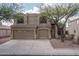 Exterior of two-story home with three-car garage and mature landscaping at 14406 N 129Th Ave, El Mirage, AZ 85335