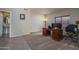 Home office with neutral walls, carpeted floors, a large desk, and natural light from a window at 14406 N 129Th Ave, El Mirage, AZ 85335