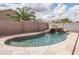 Backyard pool featuring a rock waterfall feature and decorative rocks at 14406 N 129Th Ave, El Mirage, AZ 85335