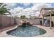 Backyard featuring a pool with rock waterfall and desert landscaping at 14406 N 129Th Ave, El Mirage, AZ 85335