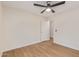 Clean bedroom features contemporary flooring, a fan, and an open doorway to another room at 14838 N 172Nd Ln, Surprise, AZ 85388