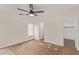 Bright bedroom showcasing wood-look floors, neutral paint, ample natural light and a convenient closet at 14838 N 172Nd Ln, Surprise, AZ 85388