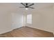 Neat bedroom features modern flooring, a ceiling fan, and a double sliding door closet at 14838 N 172Nd Ln, Surprise, AZ 85388