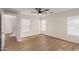 Bright bedroom features wood-look flooring, a ceiling fan, and neutral walls, creating a comfortable space at 14838 N 172Nd Ln, Surprise, AZ 85388