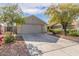 Inviting single-story home features a spacious driveway, low maintenance landscaping and an attached two-car garage at 14838 N 172Nd Ln, Surprise, AZ 85388