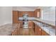 Functional kitchen featuring wood cabinets, stainless steel appliances, and durable countertops for meal preparation at 14838 N 172Nd Ln, Surprise, AZ 85388