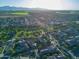 Expansive aerial view of the community with lush green landscaping and mountain views at 15289 W Valentine St, Surprise, AZ 85379