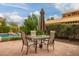 Backyard patio featuring a table and chairs with an umbrella, perfect for outdoor dining and relaxation at 15289 W Valentine St, Surprise, AZ 85379