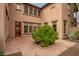 Paver patio in a private backyard with desert landscaping and a mature shade tree at 15289 W Valentine St, Surprise, AZ 85379