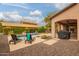 Relaxing backyard oasis with pool, lounge chairs, and outdoor grill, perfect for entertaining guests at 15289 W Valentine St, Surprise, AZ 85379