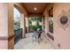 Cozy balcony setup with tiled floor, seating area, and outdoor access to the beautiful neighborhood at 15289 W Valentine St, Surprise, AZ 85379