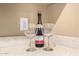 Wet bar area featuring quartz counters, and ready to entertain with wine glasses and bottle of champagne at 15289 W Valentine St, Surprise, AZ 85379