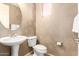 Elegant powder room features designer wallpaper, a pedestal sink, and modern fixtures at 15289 W Valentine St, Surprise, AZ 85379