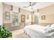 Neutral bedroom with two large windows and iron bedframe providing ample natural light at 15289 W Valentine St, Surprise, AZ 85379