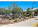 Landscaped grounds near the community clubhouse with paved walkways and flowering bushes, offering a serene environment at 15289 W Valentine St, Surprise, AZ 85379