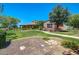 Community clubhouse with well-manicured lawns and flowering bushes, providing a beautiful welcome to residents at 15289 W Valentine St, Surprise, AZ 85379