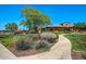 Inviting community clubhouse with lush landscaping and vibrant colors offers a welcoming space for residents at 15289 W Valentine St, Surprise, AZ 85379