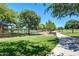 Community park features a walking path, expansive green spaces, and mature shade trees at 15289 W Valentine St, Surprise, AZ 85379