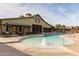 Serene community pool with fountains and a clubhouse in the background at 15289 W Valentine St, Surprise, AZ 85379