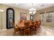 Spacious dining room with a large wood table and elegant chandelier at 15289 W Valentine St, Surprise, AZ 85379