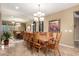 Bright dining room showcasing a large table, lighting fixture, and wall mirror at 15289 W Valentine St, Surprise, AZ 85379