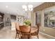 Cozy dining area with a wooden table, chairs, and decorative lighting, adjacent to the modern kitchen at 15289 W Valentine St, Surprise, AZ 85379