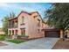 Charming two-story home with attached garage, manicured lawn and tasteful desert landscaping at 15289 W Valentine St, Surprise, AZ 85379