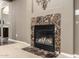 Elegant fireplace with decorative tile surround, adding a touch of sophistication to the room at 15289 W Valentine St, Surprise, AZ 85379