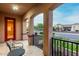 Inviting covered front porch features tile flooring, seating and wrought iron railings at 15289 W Valentine St, Surprise, AZ 85379