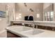 A close-up view of a kitchen sink with marble countertops and a view of the backyard at 15289 W Valentine St, Surprise, AZ 85379