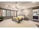 Serene main bedroom with a large bed, soft carpet, and a glimpse of the ensuite bathroom at 15289 W Valentine St, Surprise, AZ 85379