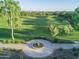 Scenic aerial view of a community park featuring lush green space, mature trees, and walking paths at 15289 W Valentine St, Surprise, AZ 85379